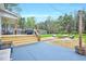 This backyard offers a patio, wooden deck, a fire pit, and ample seating for outdoor enjoyment at 1165 Shonele Ln, Stem, NC 27581