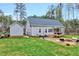 Aerial shot showing spacious backyard with deck, patio, firepit, and fenced yard at 1165 Shonele Ln, Stem, NC 27581