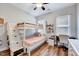 Charming bedroom featuring a bunk bed with built-in storage steps and a cozy desk area at 1165 Shonele Ln, Stem, NC 27581