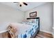 Comfortable bedroom with a queen-sized bed, built-in storage, and a large window at 1165 Shonele Ln, Stem, NC 27581