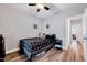 Cozy bedroom with gray walls, hardwood floors, ceiling fan and closet at 1165 Shonele Ln, Stem, NC 27581