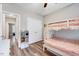 Bright bedroom showing a bunk bed with storage steps and a view into the hallway at 1165 Shonele Ln, Stem, NC 27581