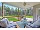 This covered patio features comfortable seating and a view of the large backyard at 1165 Shonele Ln, Stem, NC 27581