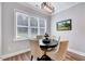 Cozy dining area with a round table, upholstered chairs, and natural light at 1165 Shonele Ln, Stem, NC 27581