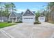 Charming home featuring gray siding, a two-car garage, and a separate one-car garage at 1165 Shonele Ln, Stem, NC 27581