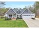 Charming home featuring gray siding, a well-manicured lawn, and a welcoming front porch at 1165 Shonele Ln, Stem, NC 27581