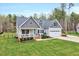 An exterior view of the home, showcasing the lawn, siding, driveway, and landscaping at 1165 Shonele Ln, Stem, NC 27581