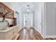 Inviting foyer featuring light gray walls, hardwood floors, and a front door at 1165 Shonele Ln, Stem, NC 27581