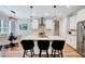 Bright kitchen featuring a center island with seating, modern appliances, and stylish pendant lighting at 1165 Shonele Ln, Stem, NC 27581