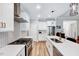 Modern kitchen with stainless steel appliances, white cabinets, and herringbone backsplash at 1165 Shonele Ln, Stem, NC 27581
