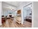 Bright living room with fireplace, hardwood floors, and doorway to bedroom at 1165 Shonele Ln, Stem, NC 27581