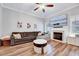 Inviting living room with fireplace, comfortable sofa, and lots of natural light at 1165 Shonele Ln, Stem, NC 27581