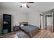 This cozy bedroom features wood-look flooring, neutral paint, a ceiling fan, and an adjacent bathroom at 120 Schultz St, Chapel Hill, NC 27514