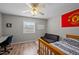 Bright bedroom with a ceiling fan, laminate flooring, and a workspace at 120 Schultz St, Chapel Hill, NC 27514