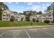 This community shot shows multiple units, lawn, and parking spaces at 120 Schultz St, Chapel Hill, NC 27514