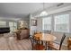 Inviting dining area with wood-look flooring, a round table, and natural light from windows at 120 Schultz St, Chapel Hill, NC 27514