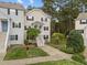 Inviting townhouse features a well-maintained exterior with a lush lawn and manicured greenery at 120 Schultz St, Chapel Hill, NC 27514