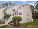 This charming two-story condo features neutral siding, dark shutters, and a staircase leading to the entrance at 120 Schultz St, Chapel Hill, NC 27514