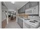 Functional kitchen features grey cabinets, tile backsplash, and essential appliances at 120 Schultz St, Chapel Hill, NC 27514