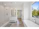 Elegant bathroom with a soaking tub, glass-enclosed shower, and modern fixtures, offering a spa-like experience at 1200 Roosevelt Dr, Chapel Hill, NC 27514