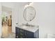 Charming bathroom features a blue vanity with marble countertop and brushed gold hardware, adding a touch of elegance at 1200 Roosevelt Dr, Chapel Hill, NC 27514