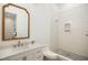 Bathroom featuring a white vanity with marble countertop, traditional mirror, and tiled shower with glass door at 1200 Roosevelt Dr, Chapel Hill, NC 27514