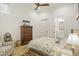 Comfortable bedroom with hardwood floors, floral bedding, ceiling fan, and view into an ensuite bathroom at 1200 Roosevelt Dr, Chapel Hill, NC 27514