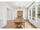 Elegant dining room featuring hardwood floors, modern lighting, and built-in display cabinet at 1200 Roosevelt Dr, Chapel Hill, NC 27514