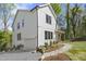 Beautiful home featuring a clean white exterior, attached garage and manicured landscaping at 1200 Roosevelt Dr, Chapel Hill, NC 27514