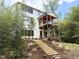A two-story home with a double deck and a landscaped yard with steps leading up to the property at 1200 Roosevelt Dr, Chapel Hill, NC 27514