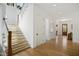 Bright foyer showcasing hardwood floors, staircase, and a view of the front door at 1200 Roosevelt Dr, Chapel Hill, NC 27514