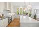 Well-appointed kitchen with marble countertops, an island, stainless appliances and an apron sink at 1200 Roosevelt Dr, Chapel Hill, NC 27514