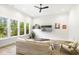 Bright living room features three large windows, a ceiling fan, and a comfortable sofa, creating a welcoming atmosphere at 1200 Roosevelt Dr, Chapel Hill, NC 27514