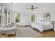 Serene main bedroom with natural light, ceiling fan, and calming decor, complete with a comfortable sitting area at 1200 Roosevelt Dr, Chapel Hill, NC 27514