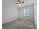 Comfortable bedroom features neutral carpet, a ceiling fan, and a bright window at 1206 Kafka Dr, Fuquay Varina, NC 27526