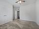 Inviting bedroom with soft carpet, a ceiling fan, and a double door closet at 1206 Kafka Dr, Fuquay Varina, NC 27526