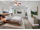 This bedroom features a tray ceiling, neutral walls, windows, and ceiling fan, providing a serene retreat at 1206 Kafka Dr, Fuquay Varina, NC 27526