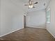 A light-filled bedroom with hardwood floors and a ceiling fan at 1206 Kafka Dr, Fuquay Varina, NC 27526
