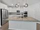The kitchen features white cabinets, stainless steel appliances, granite countertops, and modern pendant lighting at 1206 Kafka Dr, Fuquay Varina, NC 27526