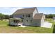 This back exterior view highlights the home's siding and covered porch with a cement pad at 125 Summerlin Dr, Clayton, NC 27527