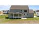 This back exterior view highlights the home's siding and a covered porch at 125 Summerlin Dr, Clayton, NC 27527