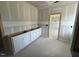 Bathroom with white cabinets and a door way that leads into another room at 125 Summerlin Dr, Clayton, NC 27527