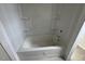 Modern bathtub and shower combination with built-in shelving for toiletries at 125 Summerlin Dr, Clayton, NC 27527