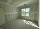 A bright bedroom with a large window offering picturesque views and natural light at 125 Summerlin Dr, Clayton, NC 27527