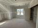 A partially finished bedroom with one window and a glimpse into a closet space at 125 Summerlin Dr, Clayton, NC 27527