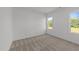 Bright bedroom features neutral carpet and two windows offering pleasant natural light and outdoor views at 125 Summerlin Dr, Clayton, NC 27527