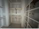 Spacious walk-in closet featuring custom shelving and hanging rods for optimal organization at 125 Summerlin Dr, Clayton, NC 27527