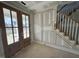 Home entryway with a glimpse of the stairway and outdoor view through glass doors at 125 Summerlin Dr, Clayton, NC 27527