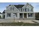 Beautiful two-story home with gray siding, dark shutters, covered porch, and architectural shingles at 125 Summerlin Dr, Clayton, NC 27527