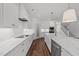 Bright, modern kitchen featuring white cabinets, a large island, and stainless steel appliances at 125 Summerlin Dr, Clayton, NC 27527